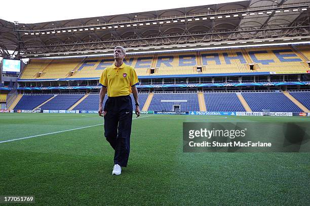 Arsenal manager Arsene Wenger inspects the pitch at the Sukru Saracoglu stadium before a Press Conference ahead of their UEFA Champions League Play...