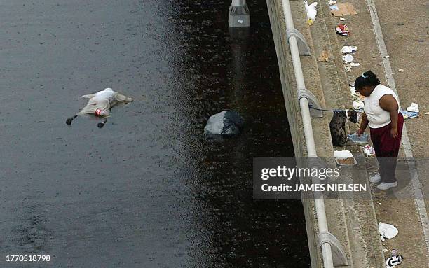 The body of a victim of Hurricane Katrina floats in floodwaters in New Orleans 01 September, 2005. Up to 300,000 survivors from the hurricane may...