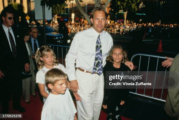 Kevin Costner, with his children Lily Costner, Joe Costner, and Annie Costner, and guests attend the Los Angeles premiere of "Waterworld", held at...