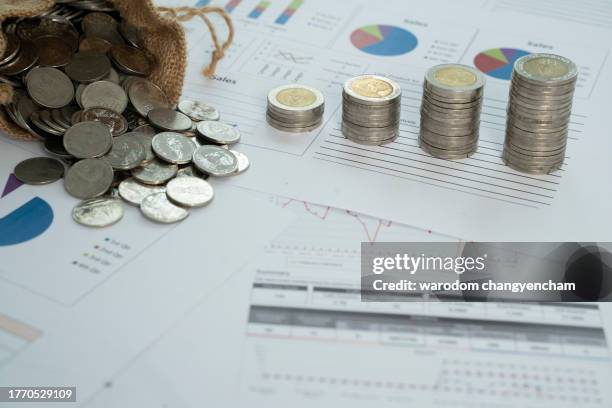 coins in sacks and coins lined up on the table. - sack imagens e fotografias de stock