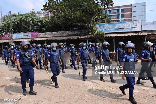 Bangladeshi policemen patrol along a street in Ashulia on November 8 a day after Minimum Wage Board authority declared the minimum wage of 12,500...