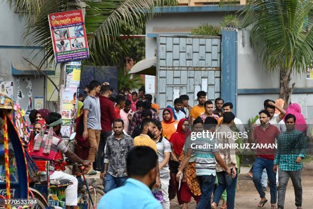 Garments workers walk off a factory at lunch break in Ashulia on November 8 a day after Minimum Wage Board authority declared the minimum wage of...