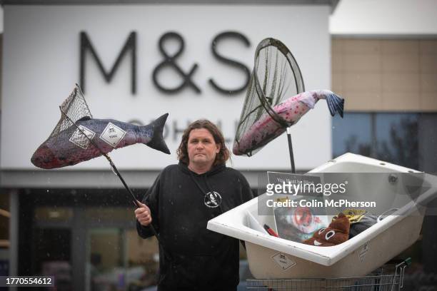 Don Staniford, director of Scamon Scotland taking part in the End Salmon Farming tour outside M&S and Aldi stores on November 2, 2023 in Bidston,...