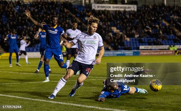 Bolton Wanderers' Dion Charles competing with Shrewsbury Town's Taylor Perry during the Sky Bet League One match between Shrewsbury Town and Bolton...