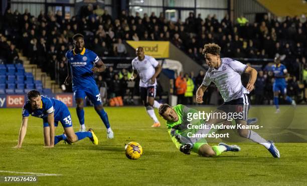 Bolton Wanderers' Dion Charles shoots at goal under pressure from Shrewsbury Town's goalkeeper Marko Marosi during the Sky Bet League One match...