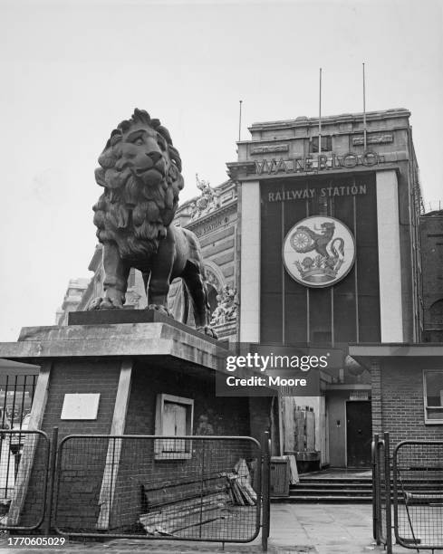 The Coade stone lion outside the main entrance to Waterloo station, a central London terminus in Lambeth, London, England, 2nd May 1964. The...