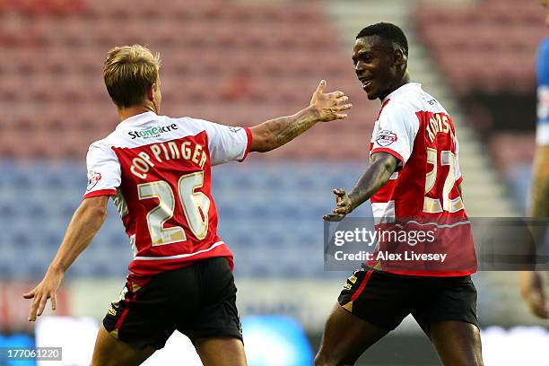 Theo Robinson of Doncaster Rovers celebrates with James Coppinger after scoring the opening goal during the Sky Bet Championship match between Wigan...