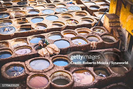 Vats of colours to dye leather skins in a tannery