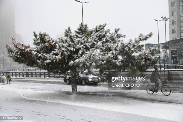 Citizens travel through heavy snow on the streets of Jilin City, Northeast China's Jilin province, Nov 8, 2023.