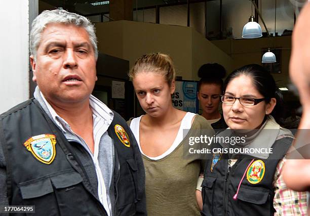 Melissa Reid , the British youth arrested on August 6, 2013 at Lima's airport carrying cocaine in her luggage is escorted out of the Callao...