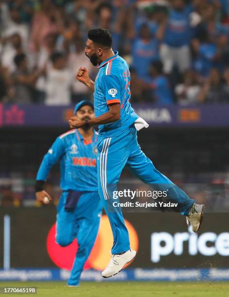 Mohammed Siraj of India celebrates the wicket of Dimuth Karunaratne of Sri Lanka during the ICC Men's Cricket World Cup India 2023 between India and...