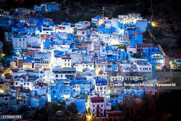 high angle view of blue painted houses at night - chefchaouen stock pictures, royalty-free photos & images