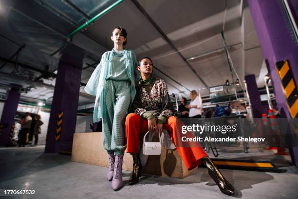 group female portrait of two fashion models indoors. behind the scenes of fashion week show, backstage photography. women behind the catwalk wear design clothing. lifestyle photo with beauty people. - model backstage stock pictures, royalty-free photos & images