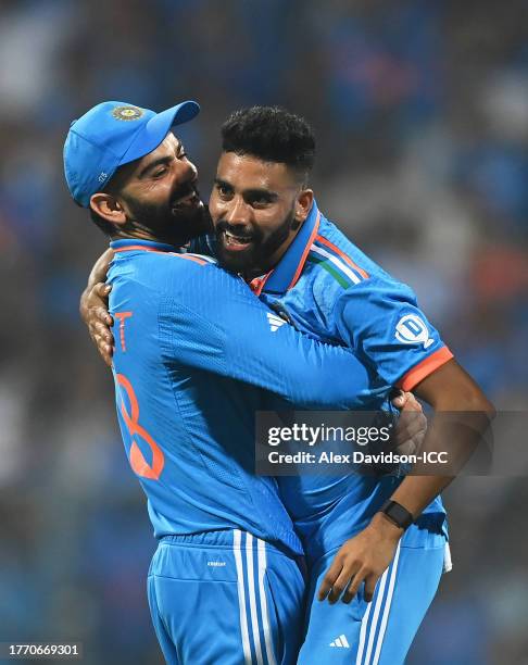 Mohammed Siraj of India celebrates the wicket of Kusal Mendis of Sri Lanka with team mate Virat Kohli during the ICC Men's Cricket World Cup India...