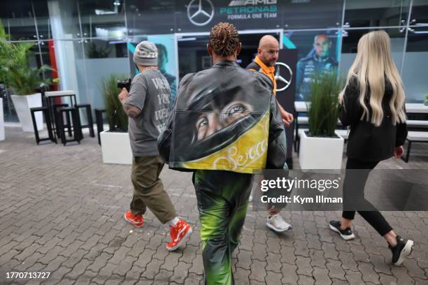 Lewis Hamilton of Great Britain and Mercedes pays homage to Ayrton Senna with his outfit during previews ahead of the F1 Grand Prix of Brazil at...