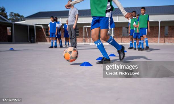 schoolboys soccer players performing warm up drills on training ground - running coach stock pictures, royalty-free photos & images