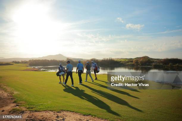 Martin Trainer of France, Stewart Cink of the United States and Matt Kuchar of the United States walk on the third hole during the first round of the...