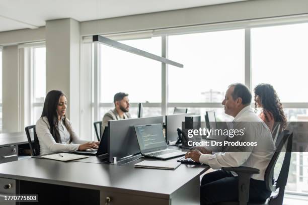 programmer working in office - programmer working stock pictures, royalty-free photos & images