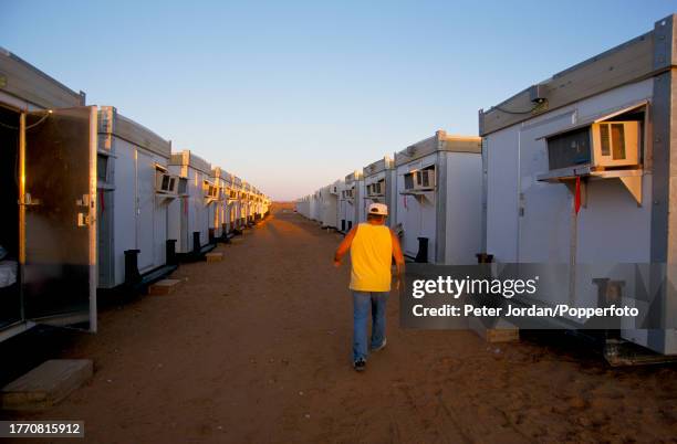An employee walks past accomodation trailers in a compound housing Bechtel construction workers building the Maghreb-Europe Gas Pipeline in the...