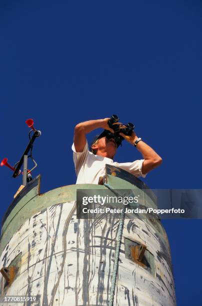 An armed guard on lookout duty with a pair of binoculars outside a compound housing Bechtel construction workers building the Maghreb-Europe Gas...