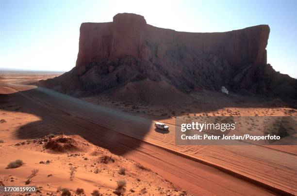 Car drives alongside a backfilled trench containing sealed and completed pipe sections during construction of the Maghreb-Europe Gas Pipeline in the...