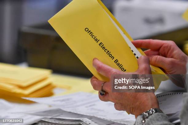 Woman takes a mail-in ballot from an envelope at a polling station in Pennsylvania. Municipal Elections in Pennsylvania had a low turnout. In the...