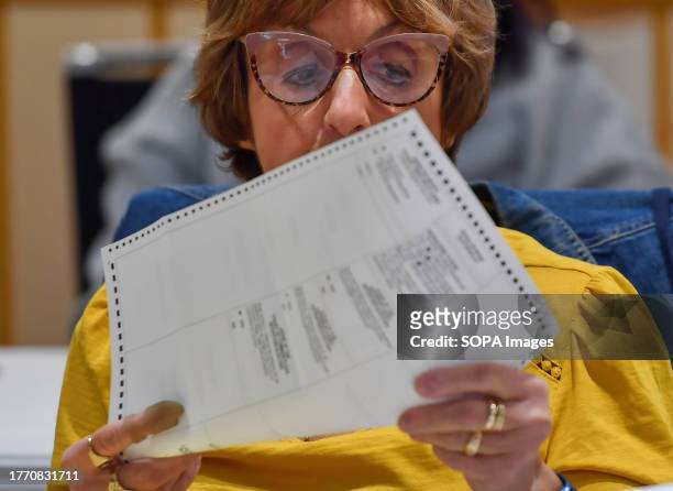 Woman looks at a mail-in ballot before it is counted at a polling station in Pennsylvania. Municipal Elections in Pennsylvania had a low turnout. In...