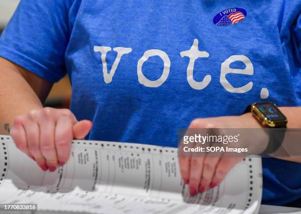 Woman wearing a Vote t-shirt prepares mail-in ballots to be counted at a polling station in Pennsylvania. Municipal Elections in Pennsylvania had a...