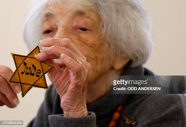 German Holocaust survivor and public speaker Margot Friedlander holds her Jewish Star of David she had to wear in Nazi Germany, as she takes part in...
