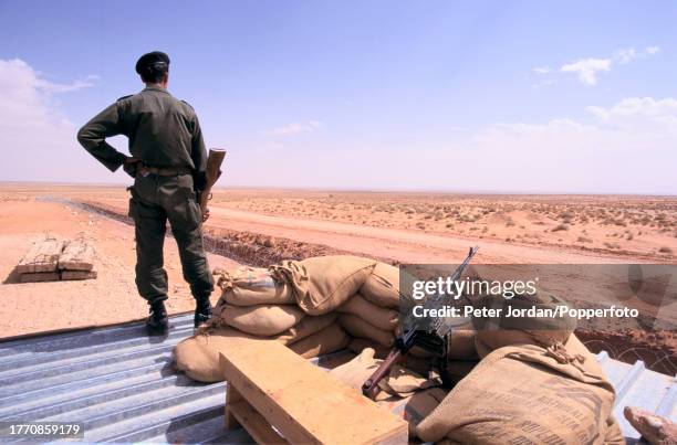 Armed guards on sentry duty at a compound housing Bechtel construction workers building the Maghreb-Europe Gas Pipeline in the desert interior of...