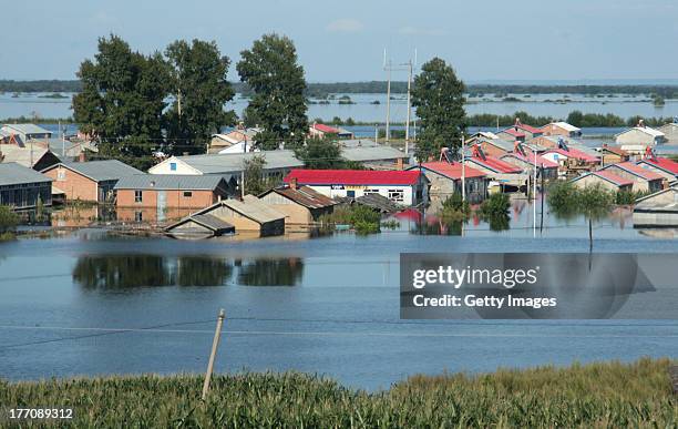 Village is submerged by flood water on August 20, 2013 in Yichun, China. 85 people were killed and 105 others missing as rainstorms have caused havoc...