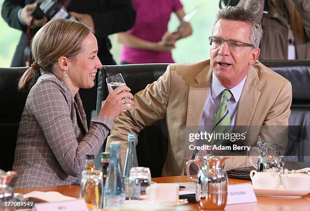 German Family Minister Kristina Schroeder and German Defense Minister Thomas de Maiziere arrive for the weekly federal Cabinet meeting on August 21,...