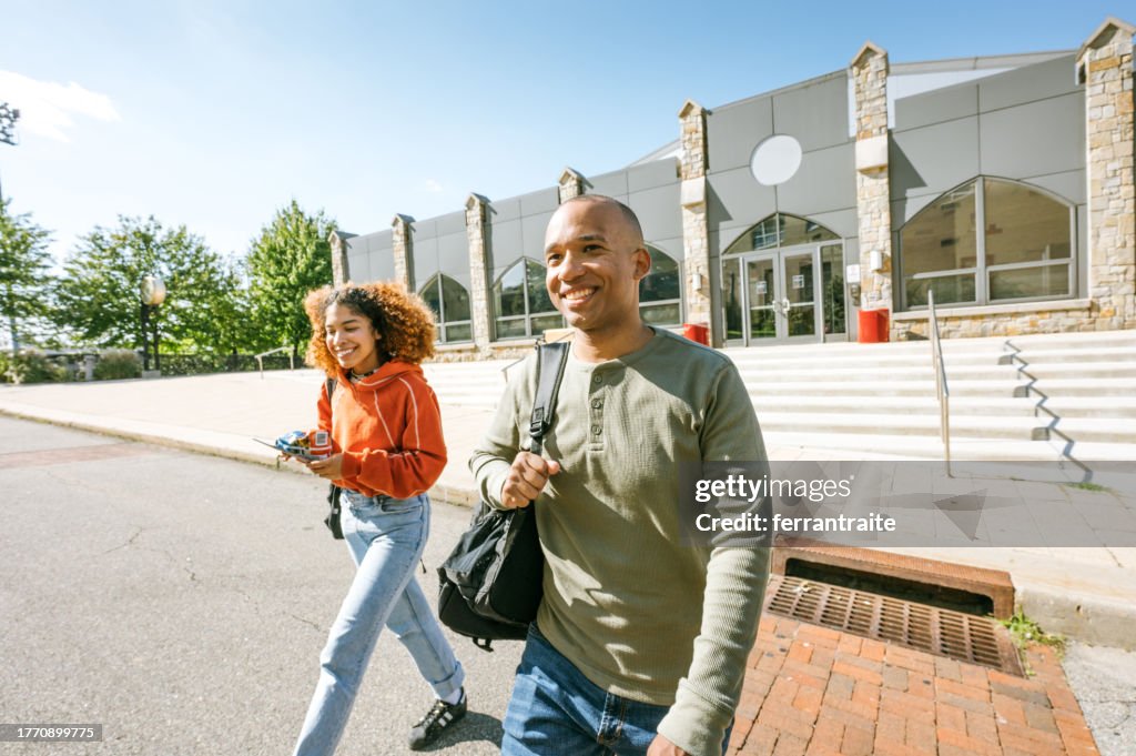 Adult students exit university building