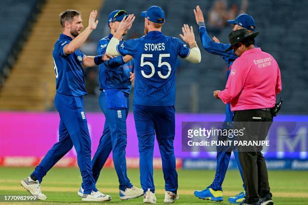 England's Chris Woakes celebrates with teammates after taking the wicket of Netherlands' Max O'Dowd during the 2023 ICC Men's Cricket World Cup...