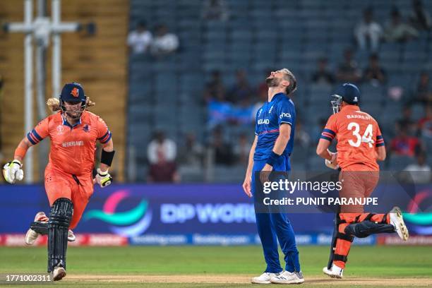 England's Chris Woakes reacts as Netherlands' Wesley Barresi and Max O'Dowd run between the wickets during the 2023 ICC Men's Cricket World Cup...