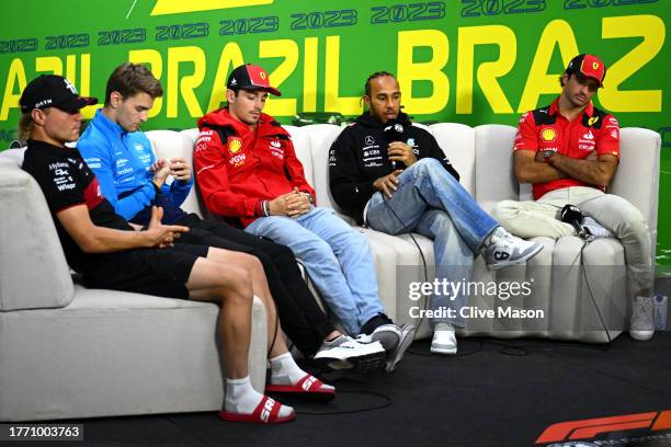 Lewis Hamilton of Great Britain and Mercedes talks in the Drivers Press Conference as Valtteri Bottas of Finland and Alfa Romeo F1, Logan Sargeant of...