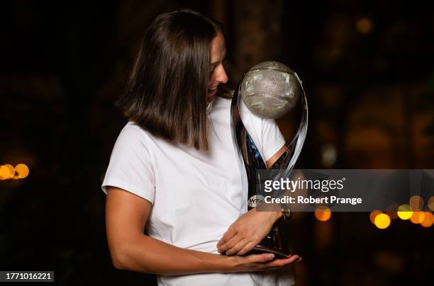 Iga Swiatek of Poland poses with the Chris Evert WTA World No.1 Trophy after winning the GNP Seguros WTA Finals Cancun 2023 part of the Hologic WTA...