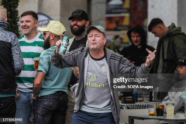 Celtic fan from Scotland raises his arms while shouting slogans in the main square of Madrid, where the Scottish fans have gathered hours before the...