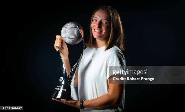 Iga Swiatek of Poland poses with the Chris Evert WTA World No.1 Trophy after winning the GNP Seguros WTA Finals Cancun 2023 part of the Hologic WTA...