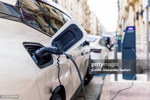 electric car charging at the electric station on the street - electric car bildbanksfoton och bilder