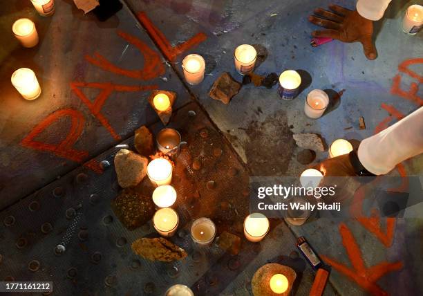 Thousand Oaks, California November 7, 2023-A blood stained sidewalk is surrounded by candles where Paul Kessler, a Jewish supporter, died after being...