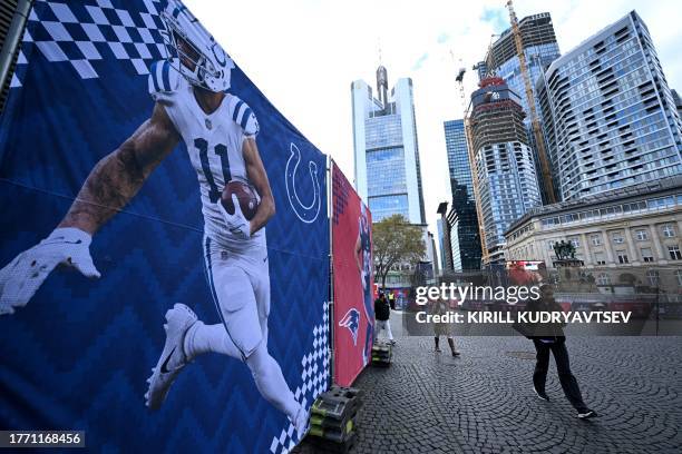 People walk past an advertising banner displaying American National Football League Indianapolis Colts wide receiver Michael Pittman Jr ahead of the...