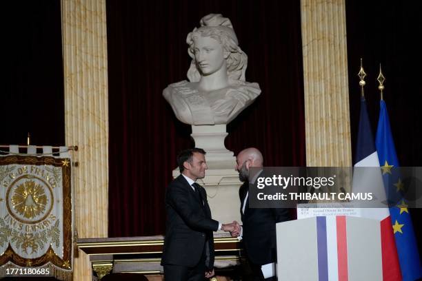 French President Emmanuel Macron shakes hands with Grand Master of the Freemasonic organisation, the Grand Orient de France Guillaume Trichard during...
