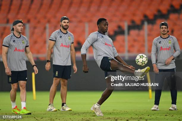 South Africa's David Miller , Aiden Markram , Kagiso Rabada and Quinton de Kock play football during a practice session ahead of their 2023 ICC Men's...