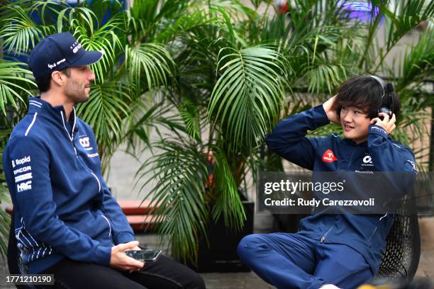 Daniel Ricciardo of Australia and Scuderia AlphaTauri and Yuki Tsunoda of Japan and Scuderia AlphaTauri talk in the Paddock during previews ahead of...