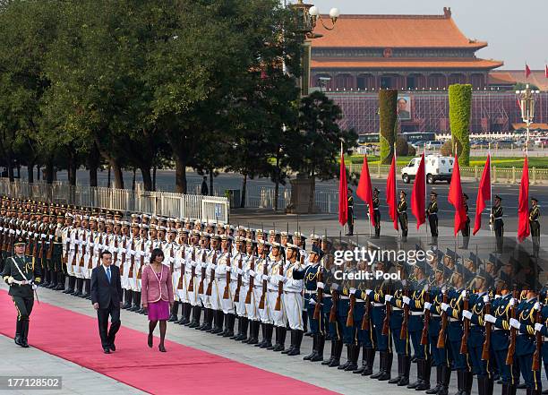 Jamaican Prime Minister Portia Simpson Miller and Chinese Premier Li Keqiang attend a welcoming ceremony at the Great Hall of the People, on August...