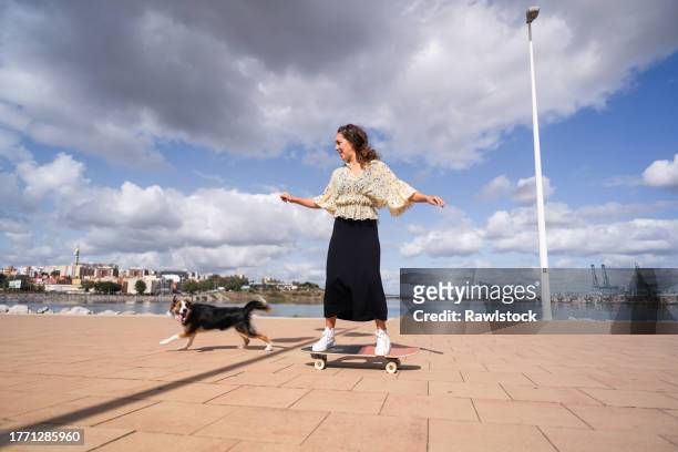 happy woman skating with her dog - algeciras stock pictures, royalty-free photos & images