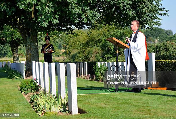 Reverend Dr Simon Bloxam-Rose speaks on August 21, 2013 during the burial of an unknown soldier at the Fifteen Ravine British Cemetery in...