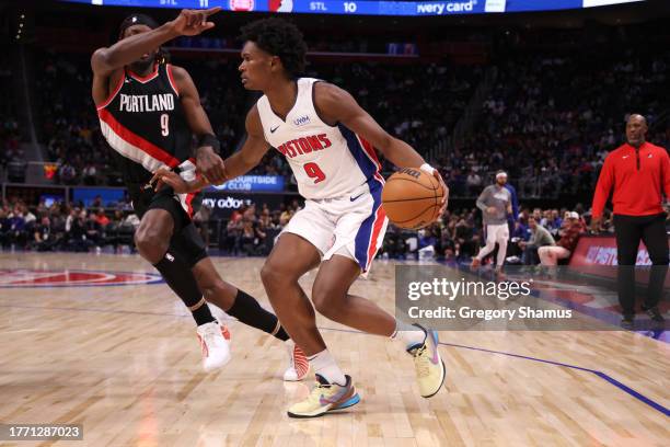 Ausar Thompson of the Detroit Pistons drives around Jerami Grant of the Portland Trail Blazers during the second half at Little Caesars Arena on...