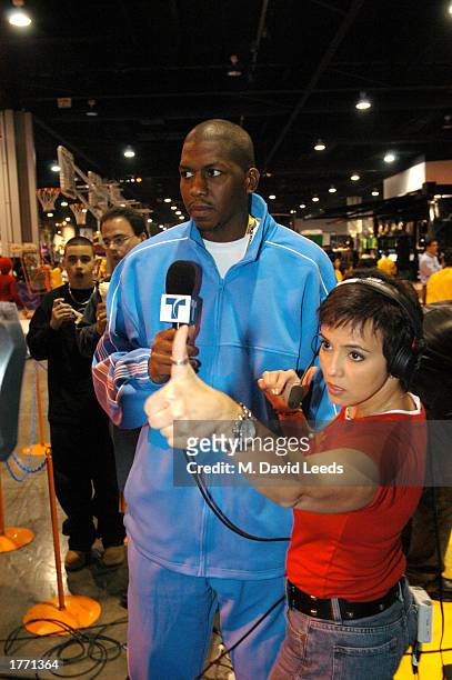 Felipe Lopez and Claudia Trejos, host of the Telemundo program "NBA Max," wait to "live" during the 2003 NBA All-Star Weekend Jam Session on February...